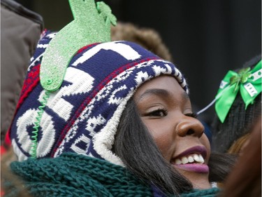 Jasmire Boursicault watches the annual St Patrick's Day parade along Ste- Catherine St. in Montreal on Sunday March 22, 2015.