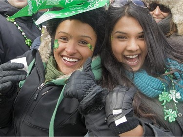 Spectators Olivia Marcoux, left, and Marilyn Jacob pause for a photograph during the annual St. Patrick's parade along Ste- Catherine St. in Montreal on Sunday March 22, 2015.