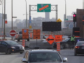 MONTREAL, QUE.: MARCH 23, 2015 -- A police officer directs traffic to Girouard Ave. from St-Jacques St. in Montreal, on Monday, March 23, 2015. A section of St. Jacques, a major thoroughfare to get downtown, will be closed for 2.5 years. (John Kenney / MONTREAL GAZETTE)