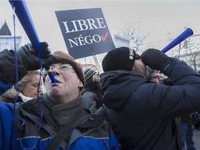 Montreal white collar protesters blow noisemakers in front of Montreal city hall on Monday March 23, 2015. The protest is in responses to cuts proposed by the city administration.