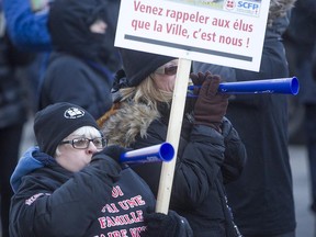 Montreal white-collar protesters blow noisemakers in front of Montreal City Hall on Monday, March 23, 2015.