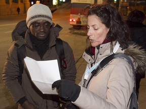 Volunteer Julie Desormeau, right, does survey for the Montreal homeless count, talking with Jacques Bouadou, who was walking on Peel St. near St-Jacques St. on Tuesday, March 24, 2015.