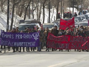 Striking Université de Montréal students march on Côte St. Catherine Road after an anti-austerity demonstration in front of St-Justine hospital  with the union representing hospital workers in Montreal, Wednesday March 25, 2015.