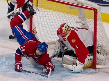 Canadiens centre Tomas Plekanec gets tripped up and falls in to Florida Panthers goalie Roberto Luongo's goal crease during NHL action at the Bell Centre in Montreal on Saturday March 28, 2015.