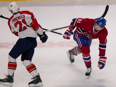 Canadiens centre Lars Eller, right, and Florida Panthers centre Vincent Trocheck hold on to each other's sticks as the tussle for the puck during NHL action at the Bell Centre in Montreal on Saturday March 28, 2015.