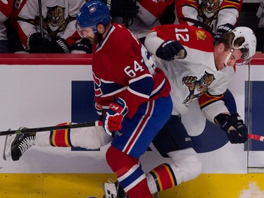 Canadiens defenceman Greg Pateryn drives Florida Panthers right wing Jimmy Hayes, right, into the boards during NHL action at the Bell Centre in Montreal on Saturday March 28, 2015.