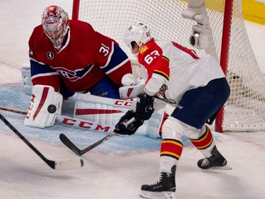 Canadiens goalie Carey Price, left, makes a save against Florida Panthers centre Dave Bolland during NHL action at the Bell Centre in Montreal on Saturday March 28, 2015.