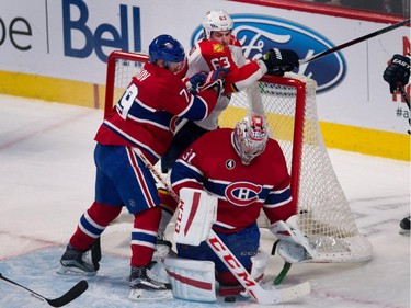 Canadiens goalie Carey Price covers the puck as defenceman Andrei Markov, left, pins Florida Panthers centre Dave Bolland to the net during NHL action at the Bell Centre in Montreal on Saturday March 28, 2015.