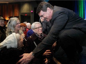 Parti Québécois leadership hopeful Pierre Karl Péladeau talks with supporters at the end of a leadership debate in Sherbrooke  Sunday.