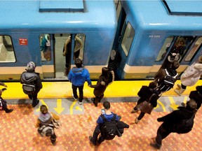 STM customers wait for the métro at the Lionel-Groulx métro station in Montreal on Tuesday March 3, 2015.