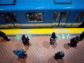 STM customers wait for the metro at the Lionel-Groulx metro station in Montreal on Tuesday March 3, 2015.