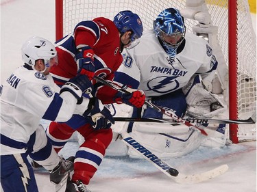 Montreal Canadiens' Alex Galchenyuk gets in close on Tampa Bay Lightning goalie Ben Bishop while Anton Stralman moves in during second-period action in Montreal on Monday, March 30, 2015.