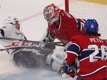 Montreal Canadiens goalie Carey Price is brought down by Tampa Bay Lightning's Alex Killorn during first-period action in Montreal on Monday, March 30, 2015.