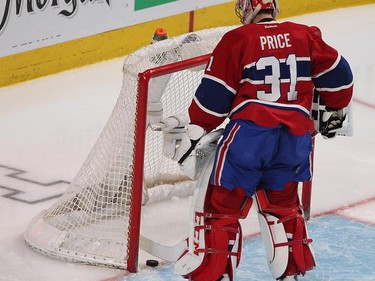 Montreal Canadiens goalie Carey Price gets puck out of net following goal by Tampa Bay Lightning's Vladislav Namestnikov during second-period action in Montreal on Monday, March 30, 2015.