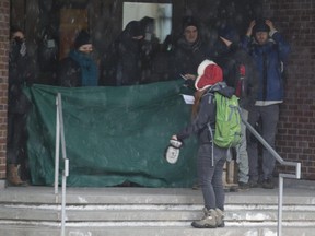 Protesters block one of the entrances to Université du Québec à Montréal (UQAM) in Montreal, Monday March 30, 2015.