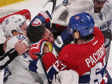 Tampa Bay Lightning goalie Ben Bishop, centre with no helmet, in a skirmish with Montreal Canadiens' Max Pacioretty during third period in Montreal on Monday, March 30, 2015.