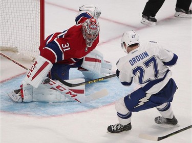 Tampa Bay Lightning's Jonathan Drouin scores on Montreal Canadiens goalie Carey Price during second-period action in Montreal on Monday, March 30, 2015.