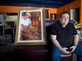 MONTREAL, QUE.: MARCH 5, 2015 -- Abie Haim with a portrait of his late father Johnny Haim at the new location of his restaurant, Abie's, in the Pointe-Claire area of Montreal Thursday, March 5, 2015. Abie's has offered West Islanders a taste of the upper Main since 1999. But in January, the popular West Island deli closed its doors. The windows of the St. John Blvd. establishment were papered up. No signs were left on the windows telling customers what had happened. Abie Haim, Abie's owner said he had to close down because his lease had ended and he couldn't agree to the new terms. He is in the process of renovating a new space  in the Blue Haven shopping mall and preparing to open up soon. Johnny, who died in 2012, and Abie both worked at Schwartz's on St. Laurent Blvd. (John Kenney / MONTREAL GAZETTE)