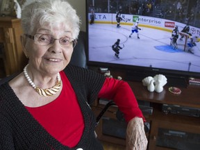 Eva Clavel, a longtime Canadiens fan who will celebrate her 90th birthday on March 10, sits in front of the TV she watches every Canadiens game on at her Montreal apartment on March 6, 2015. Clavel likes the large screen so her favourite player, Max Pacioretty, can jump out and reach her.