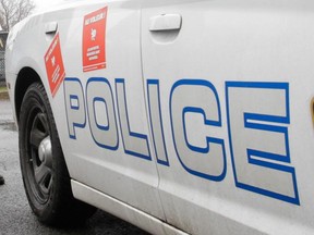 MONTREAL, QUE.: NOVEMBER 23, 2014 -- Châteauguay police constables Tanya Plourde (left) and Robyn McGill-Porcheron at the Châteaguay police station near Montreal Sunday, November 23, 2014 after a call wearing a cowboy hats and sherrif's badges. Police in the South Shore community have donned the non-regulation uniform to highlight what they say is their special punishment doled out by the government's proposed change to the pension plans of municipal employees. (John Kenney / MONTREAL GAZETTE)