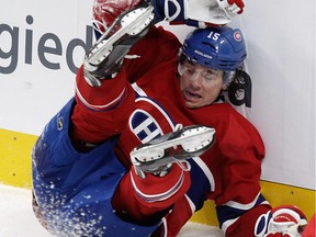 P.A. Parenteau hits the back boards after being upended by a Detroit Red Wings player in the second period in NHL action at the Bell Centre in Montreal on Tuesday, October 21, 2014.