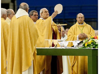 Cardinal Jean-Claude Turcotte performs mass during the thanksgiving mass for the canonization of Brother Andre at Montreal's Olympic Stadium on Saturday October 30, 2010.
