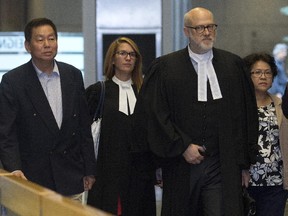 Sy Veng Chun and Leng Ky Lech, a couple accused of money laundering, along with their legal team make their way to the courtroom in Montreal, Monday September 15, 2014.