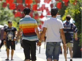 Men walk in the Gay Village in Montreal Monday, July 26, 2010 before the start of Divers/Cité 2010.