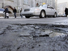 Motorists steer past a pothole on a Montreal street in 2005.