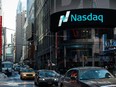 Cars drive past the NASDAQ MarketSite on March 2, 2015 in New York City.