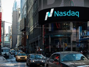 Cars drive past the NASDAQ MarketSite on March 2, 2015 in New York City.