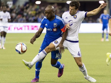 Montreal Impact's Nigel Reo-Coker and Orlando City SC's Sean St. Ledger battle for the ball during second half MLS action on Saturday, March 28, 2015, in Montreal.