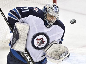 Winnipeg Jets goalie Ondrej Pavelec makes a save against the Oilers during game in Edmonton on March 23, 2015.