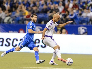 Aurelien Collin #78 of Orlando City SC tries to move the ball away from Montreal Impact during the MLS game at the Olympic Stadium on March 28, 2015, in Montreal.