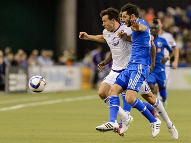 Sean St. Ledger #4 of the Orlando City SC and Ignacio Piatti #10 of Montreal Impact chase the ball during the MLS game at the Olympic Stadium on March 28, 2015, in Montreal.