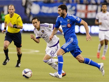 Ignacio Piatti #10 of Montreal Impact tries to move the ball past Eric Avila #12 of Orlando City SC during the MLS game at the Olympic Stadium on March 28, 2015, in Montreal, Quebec, Canada.