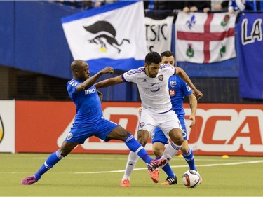 Nigel Reo-Coker #14 of Montreal Impact challenges Pedro Ribeiro #15 of Orlando City SC during the MLS game at the Olympic Stadium on March 28, 2015 in Montreal, Quebec, Canada.