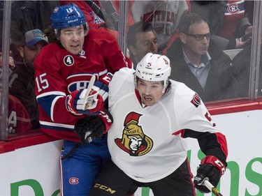 Montreal Canadiens' P.A. Parenteau is checked into the boards by Ottawa Senators' Cody Ceci during first-period action at the Bell Centre on Thursday, March 12, 2015.