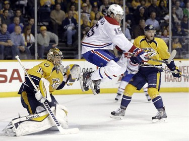 Montreal Canadiens right wing P.A. Parenteau jumps out of the way of a shot as Nashville Predators goalie Pekka Rinne of Finland guards the net in the second period Tuesday, March 24, 2015, in Nashville, Tenn.