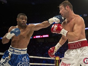 Jean Pascal (left) connects with a left on Lucian Bute during their WBC Diamond and NABF Light Heavyweight title fight Saturday, Jan. 18, 2014, in Montreal. Pascal will face light heavyweight champion Sergey (Crusher) Kovalev on March 14 at the Bell Centre, the fight promoters announced Wednesday.