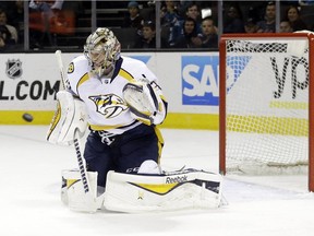 Nashville Predators goalie Pekka Rinne stops a shot against the San Jose Sharks during the first period of an NHL hockey game Thursday, March 12, 2015, in San Jose, Calif.