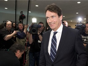 Newly elected Parti Quebecois MNA Pierre Karl Peladeau walks in to the Parti Quebecois special caucus Thursday, April 10, 2014 in Quebec City.