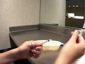 A client administers drugs at Insite, a safe injection site on Hastings Street in Vancouver.  Handout photo