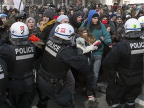 Police disperse demonstrators as students protest against proposed austerity changes by the provincial government, Monday, March 23, 2015 in Montreal.