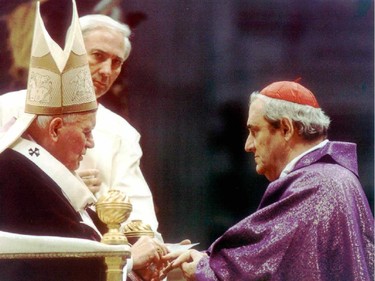 Pope John Paul places a Cardinal's ring on the finger of Jean-Claude Turcotte, Archbishop of Montreal during a ceremony in the Vatican.