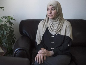Wearing the Hijab when she went to court, Rania El-Alloul poses for a photograph at her home in Montreal, Saturday, February 28, 2015. A crowdfunding campaign in support of El-Alloul, who was refused her day in court because she was wearing a hijab, has raised more than $20,000 in its first day.