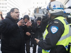 Alexandre Paradis is confronted by police during a demonstration timed to coincide with  the St. Patrick's parade Sunday.