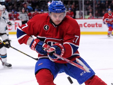 Alex Galchenyuk of the Montreal Canadiens takes a shot at the airborne puck during the NHL game against the San Jose Sharks at the Bell Centre on March 21, 2015, in Montreal,.