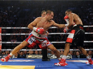 Sergey Kovalev (left) land a body punch on Jean Pascal during their unified light heavyweight championship bout at the Bell Centre on March 14, 2015 in Montreal, Quebec, Canada.