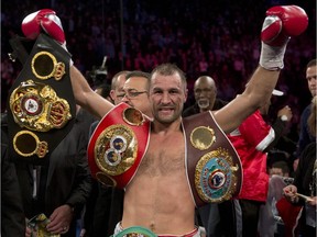 Sergey Kovalev,from Russia, holds up his belts after defeating Jean Pascal, from Montreal, with an 8th round TKO Saturday, March 14, 2015 in Montreal. Kovalev defends his World Boxing Association, International Boxing Federation and World Boxing Organization light-heavyweight titles.